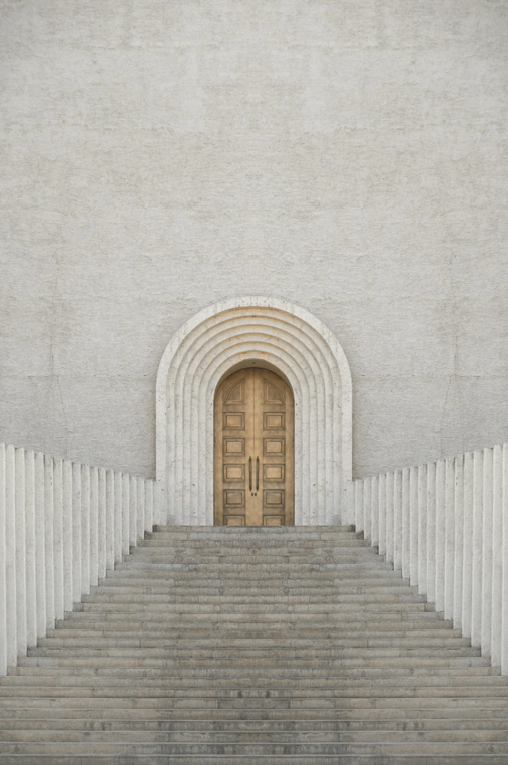 A wide stone staircase rising to a warm arched doorway.