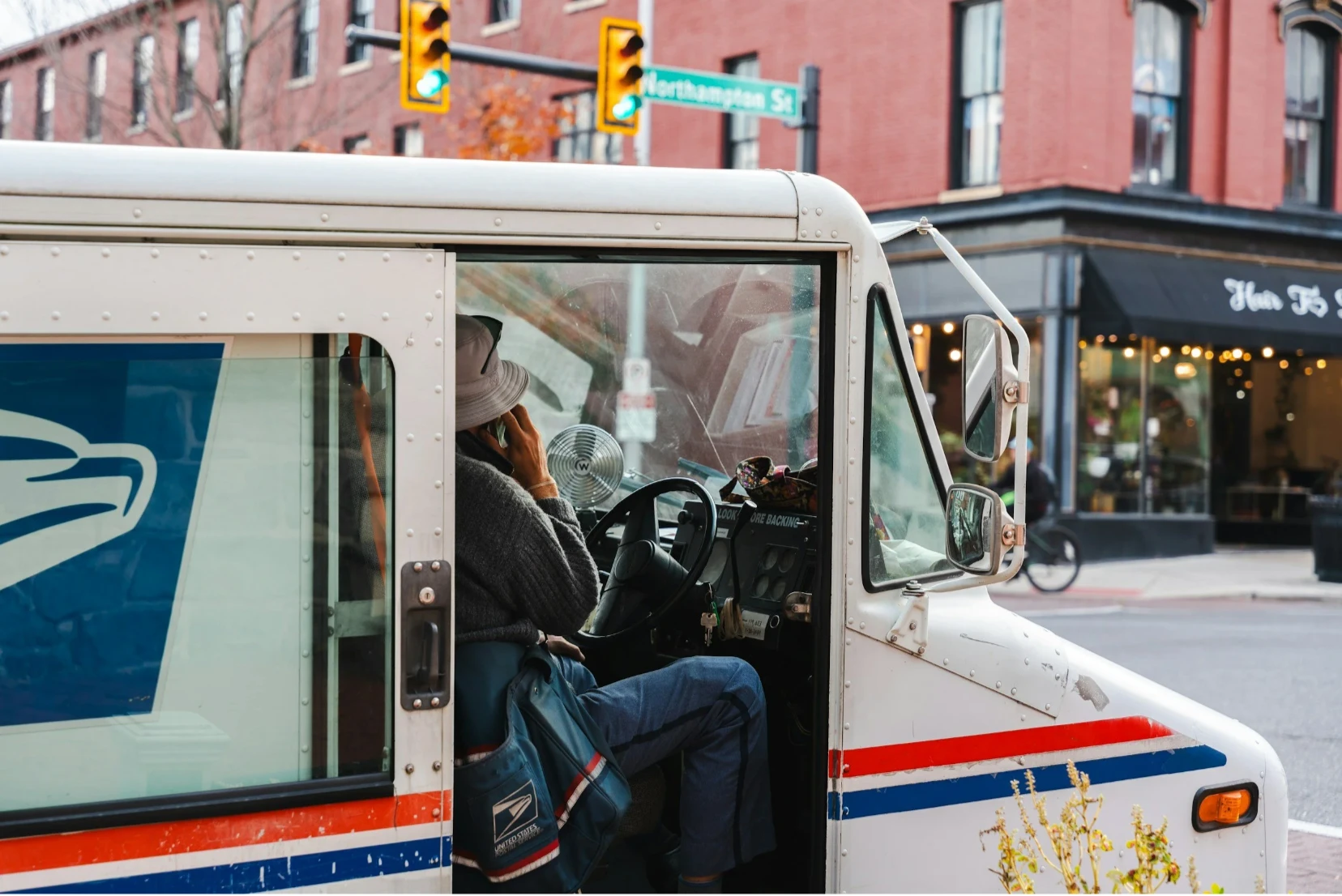 A United States Postal Service letter carrier at work in a mail truck